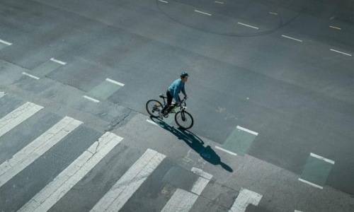 a person riding a bicycle on a street